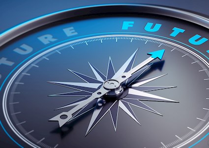 Photograph shows a compass needle pointing toward the word “future.” 