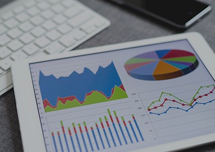 Four colorful graphs displayed on a tablet
