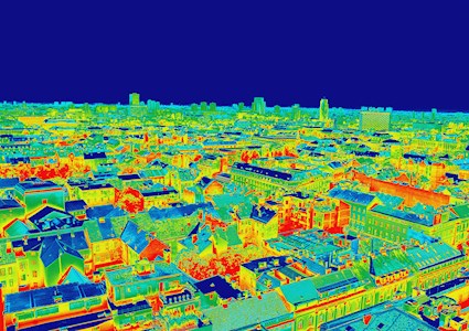 Image shows a cityscape that has been colored to reflect different temperatures. Red/orange is the warmest and blue is the coolest. 