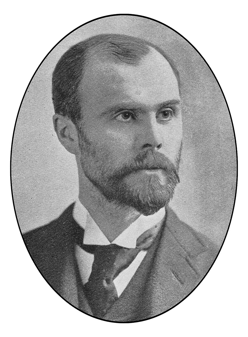 Man with a bear wearing a jacket and tie. 