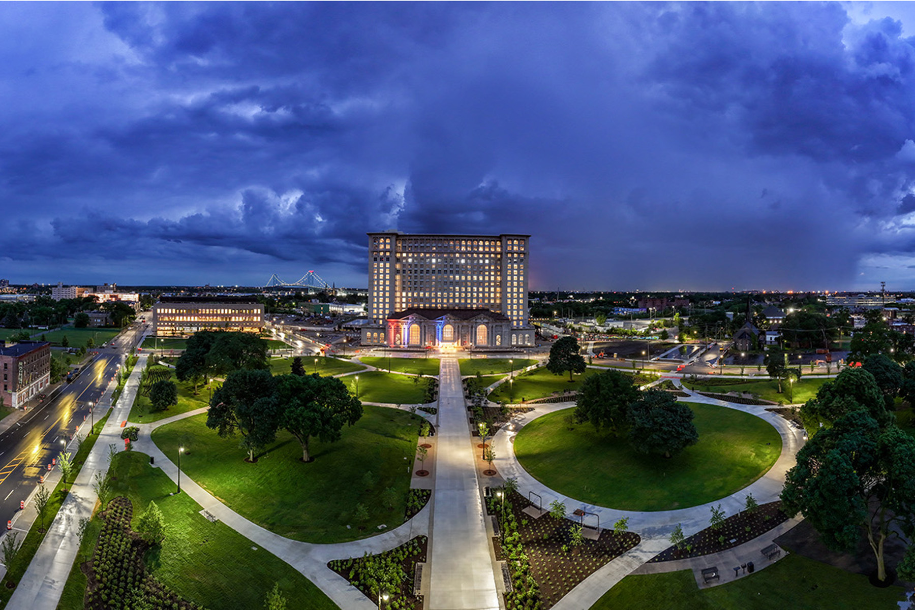 The station is shown at night, surrounded by trees and other greenery.