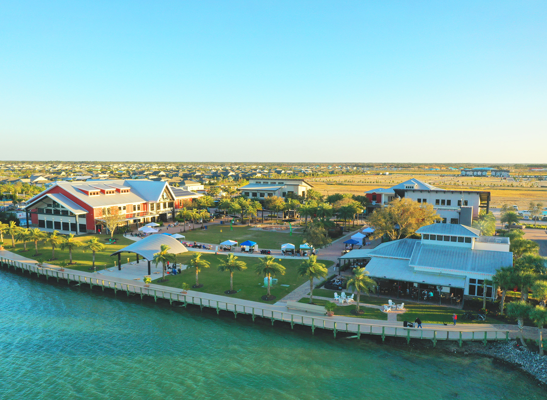 Palm trees and community buildings line the Babcock Ranch lakefront. 
