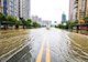 Photograph shows a flooded street. 
