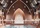 people swim in a pool with church elements on walls