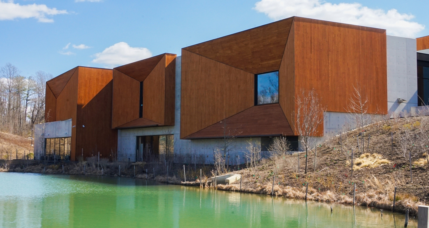 a timber-heavy building sits along the water