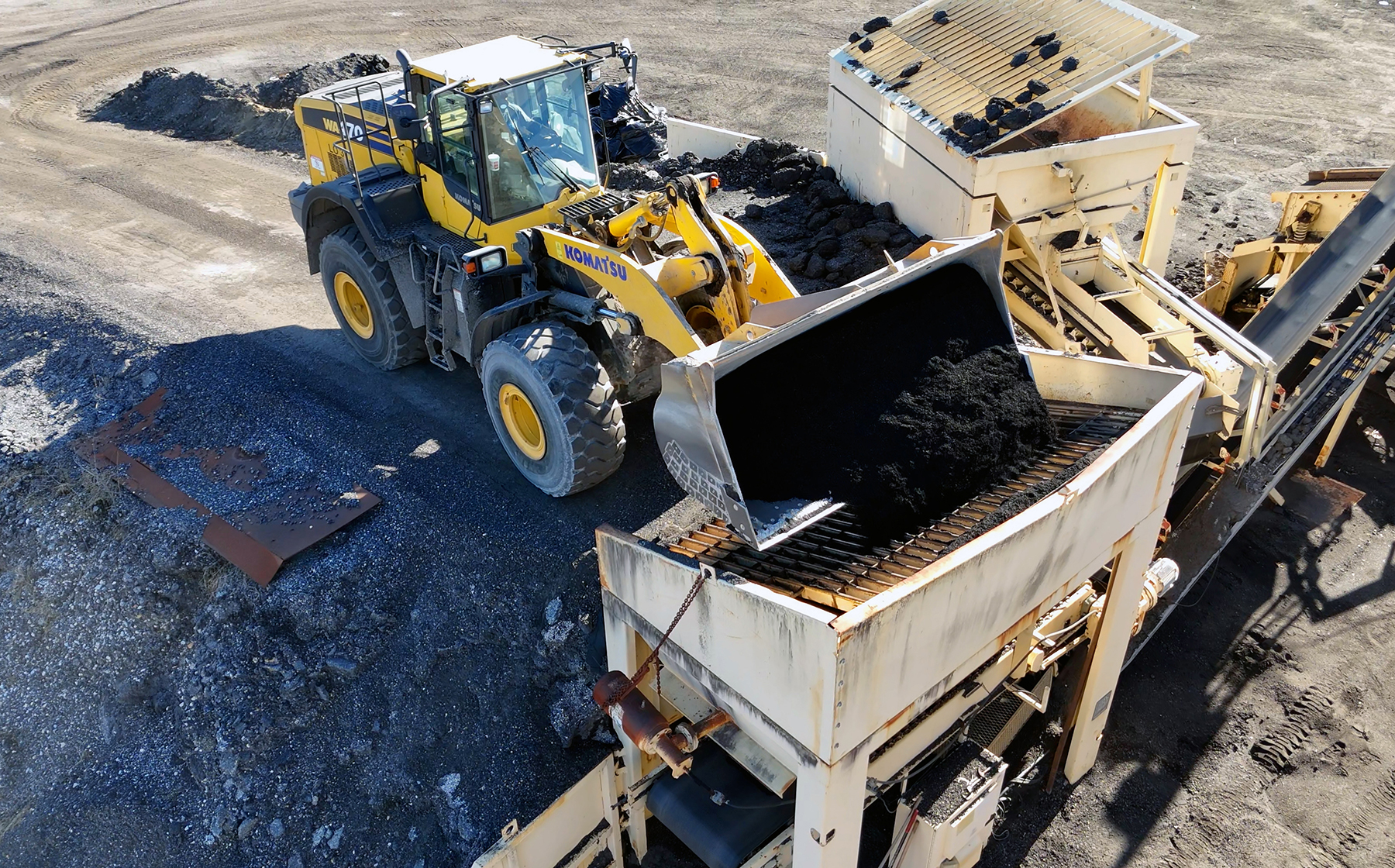 heavy machinery prepares the asphalt