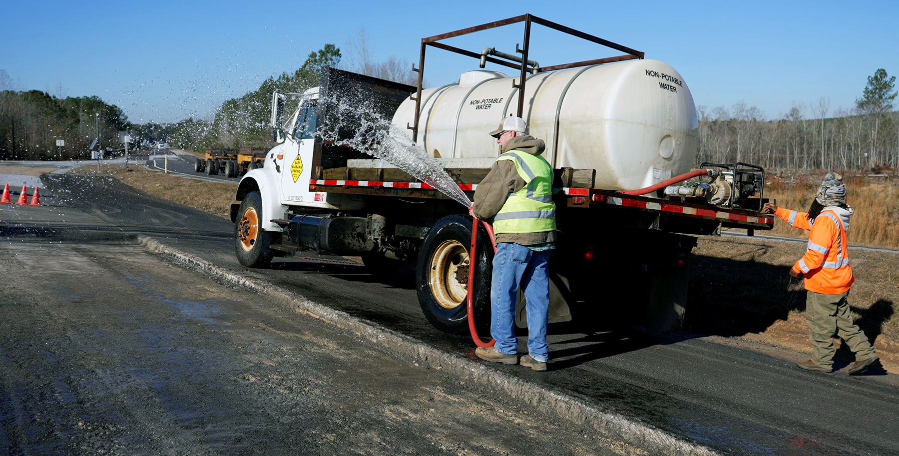 crew and a trucck works with the asphalt